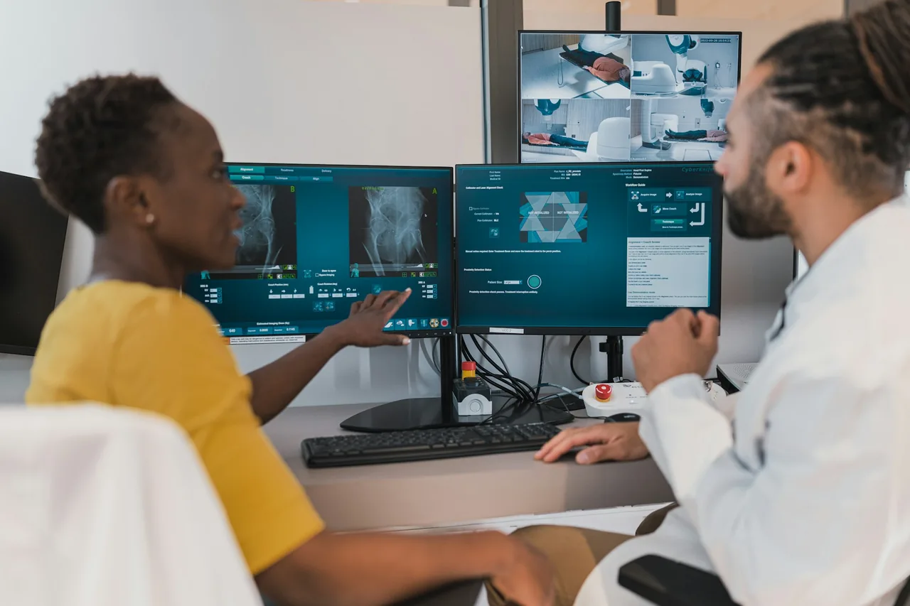 Clinical team reviewing device workflows across multiple screens